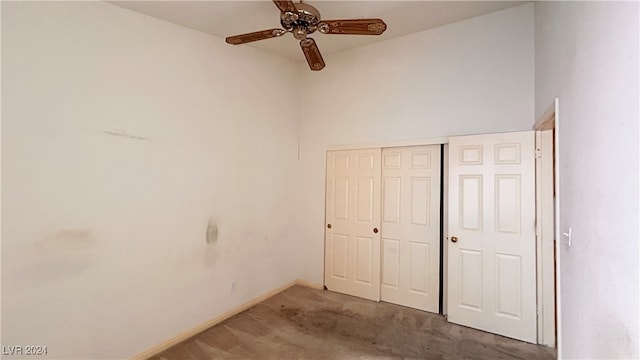 unfurnished bedroom with carpet flooring, ceiling fan, and a closet