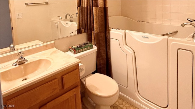 bathroom featuring vanity, toilet, and a bathtub