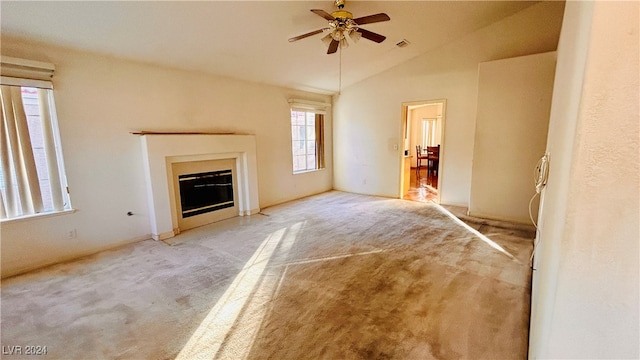 unfurnished living room with a fireplace, light colored carpet, ceiling fan, and lofted ceiling