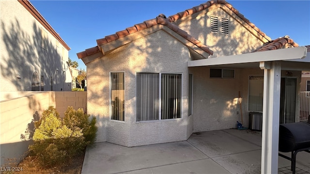 rear view of property featuring a patio area