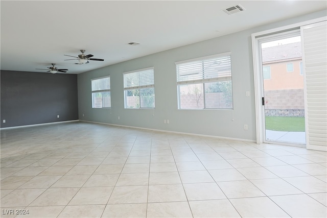 tiled spare room featuring ceiling fan