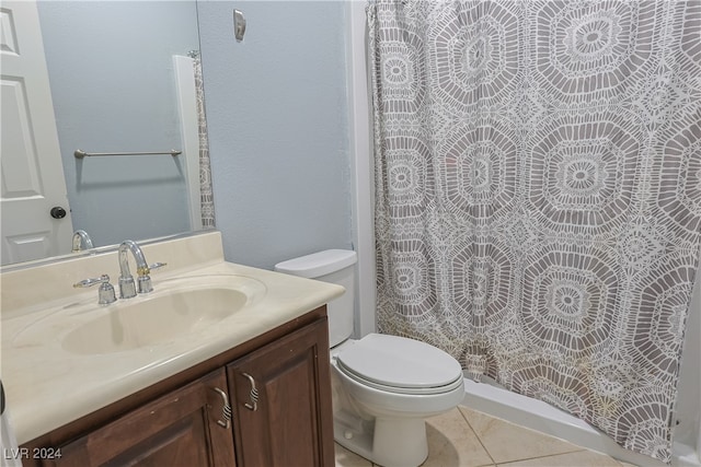 bathroom featuring vanity, toilet, tile patterned floors, and a shower with curtain