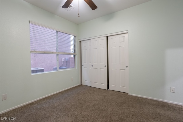 unfurnished bedroom featuring a closet, ceiling fan, and carpet floors