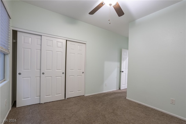 unfurnished bedroom featuring a closet, carpet, and ceiling fan