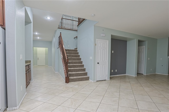 staircase featuring tile patterned flooring