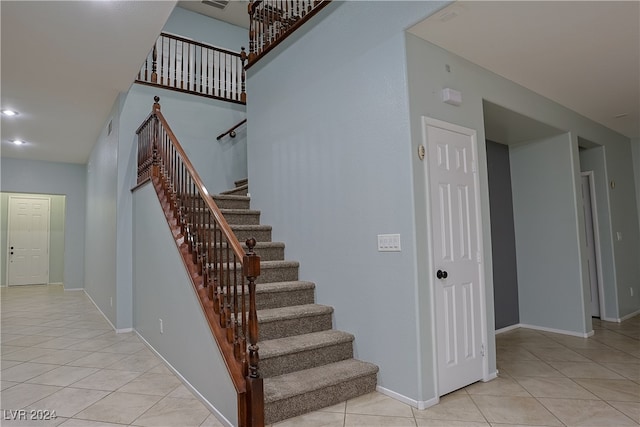 stairway featuring tile patterned flooring