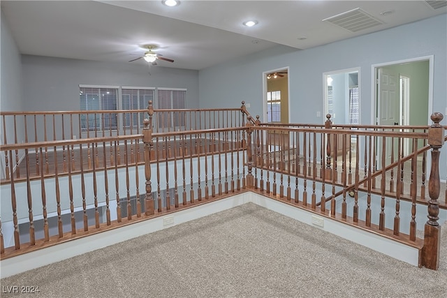 empty room featuring ceiling fan and carpet