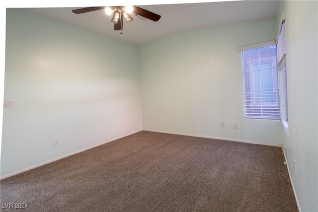 carpeted spare room with lofted ceiling and ceiling fan