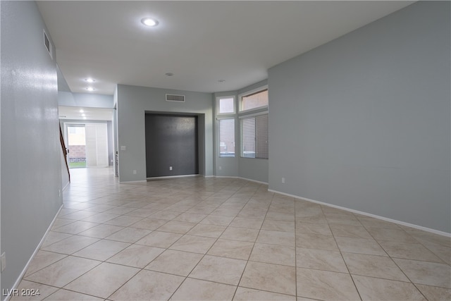 tiled empty room with a wealth of natural light