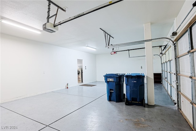 garage featuring washer / dryer and a garage door opener