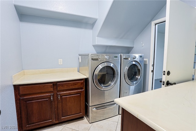 laundry area featuring cabinets, separate washer and dryer, and light tile patterned floors