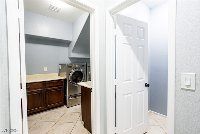 clothes washing area featuring separate washer and dryer and light tile patterned floors