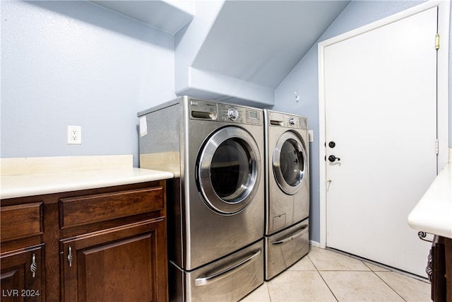 laundry room featuring separate washer and dryer and light tile patterned floors