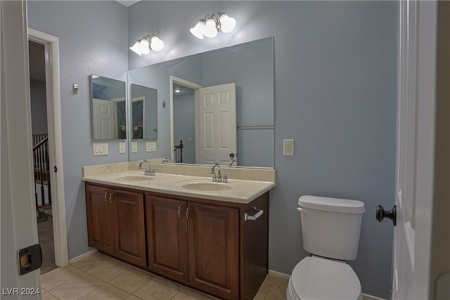 bathroom with vanity, toilet, and tile patterned floors