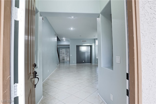 hall with light tile patterned flooring