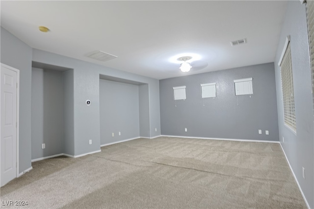 basement featuring light carpet