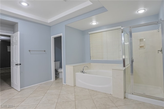 bathroom featuring tile patterned flooring, toilet, and shower with separate bathtub