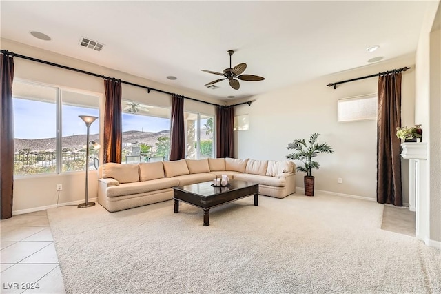 tiled living room featuring a mountain view and ceiling fan