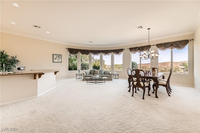 dining area featuring crown molding, a mountain view, light carpet, and an inviting chandelier