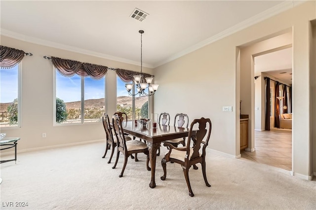 carpeted dining area with a mountain view, a notable chandelier, and ornamental molding