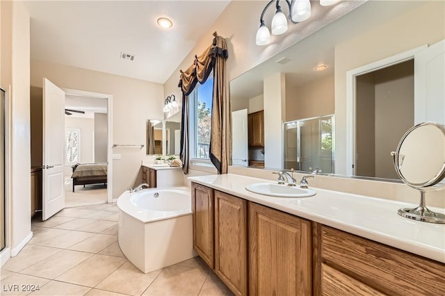 bathroom with vanity, tile patterned flooring, and plus walk in shower