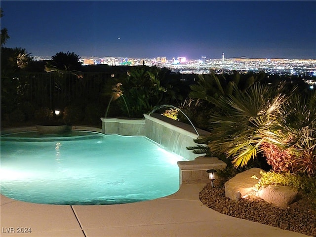 pool at night with pool water feature