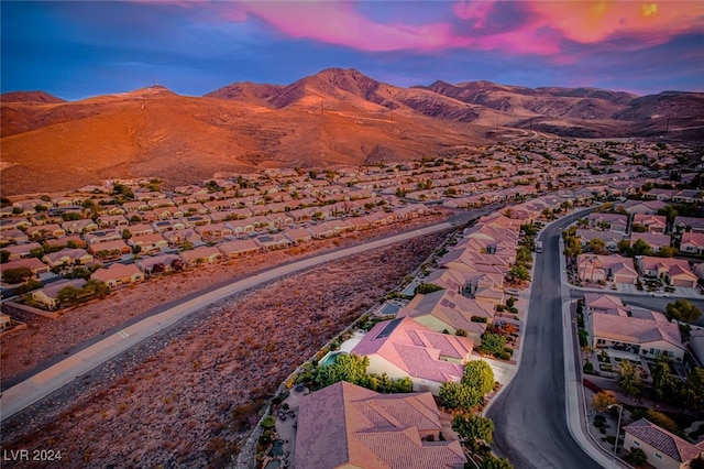 aerial view at dusk featuring a mountain view