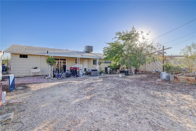 back of property with a patio and central AC