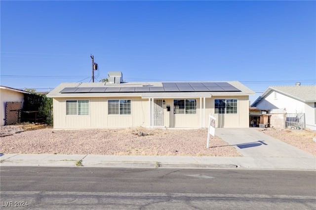 view of front of property with solar panels