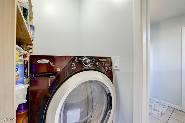 washroom with washer / dryer and light tile patterned floors