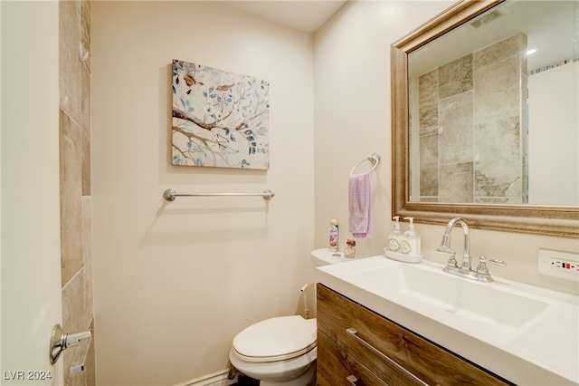 bathroom featuring toilet and vanity