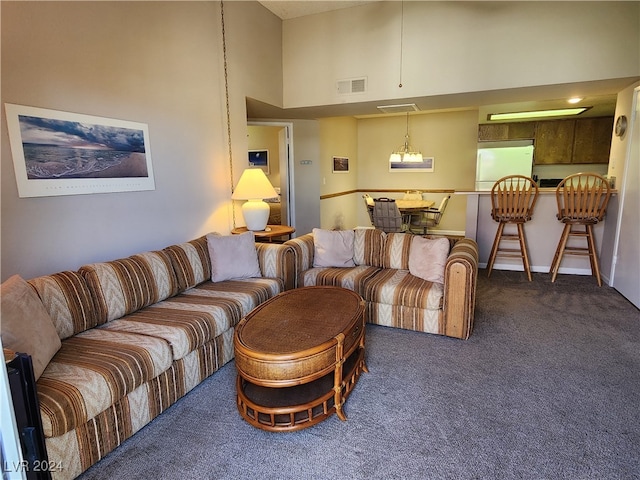 carpeted living room featuring a high ceiling