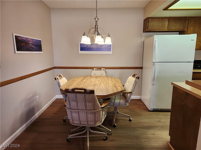 dining space featuring a notable chandelier and dark hardwood / wood-style flooring