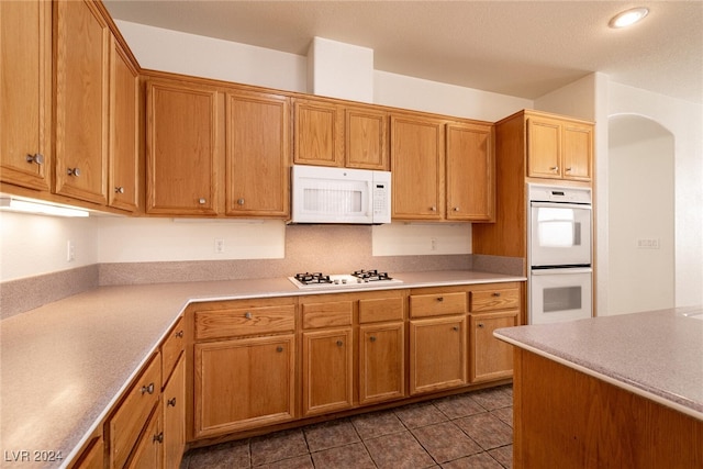 kitchen with tile patterned flooring and white appliances