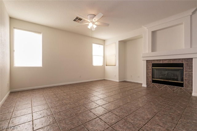 unfurnished living room featuring a fireplace and ceiling fan