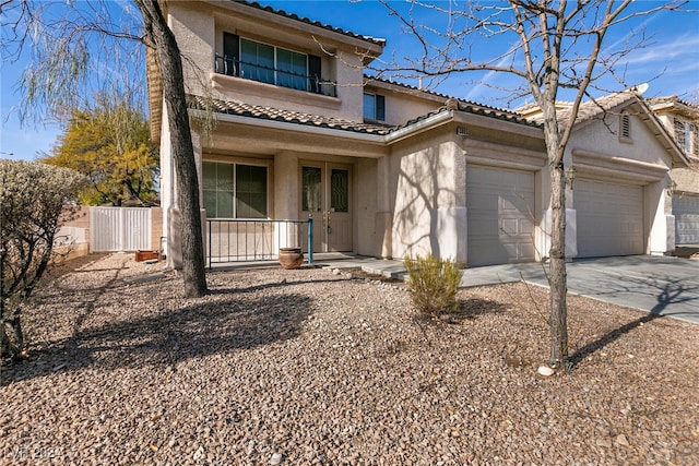 view of front of home featuring covered porch and a garage