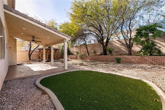 view of yard with a patio area and ceiling fan