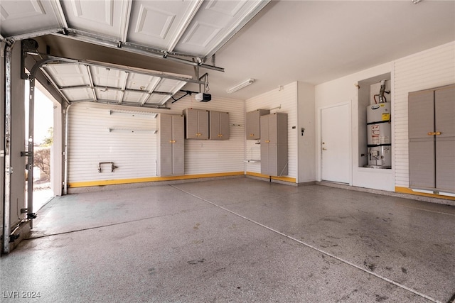 garage with secured water heater and a garage door opener