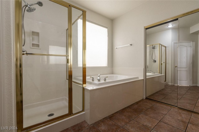 bathroom featuring tile patterned floors and separate shower and tub