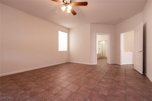 tiled empty room featuring ceiling fan