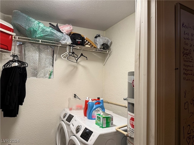 washroom featuring independent washer and dryer and a textured ceiling