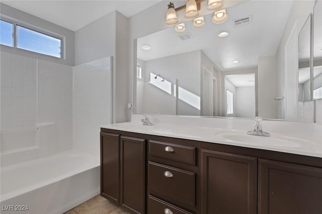 bathroom with tile patterned flooring, vanity, and washtub / shower combination