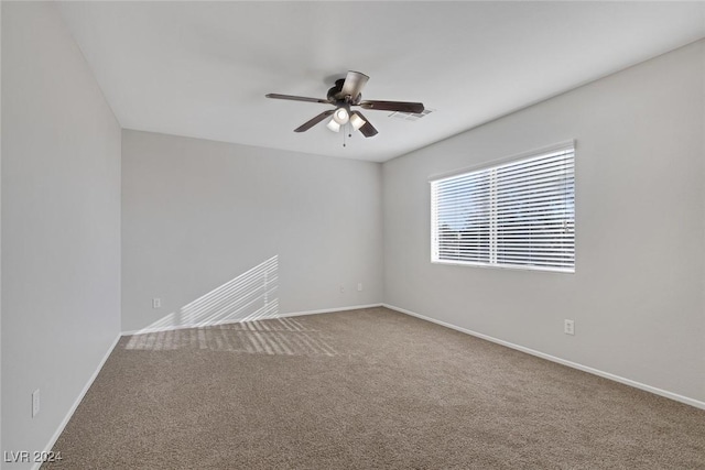 empty room with ceiling fan and carpet floors