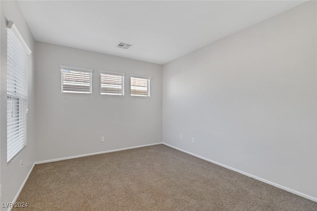 unfurnished room with carpet floors