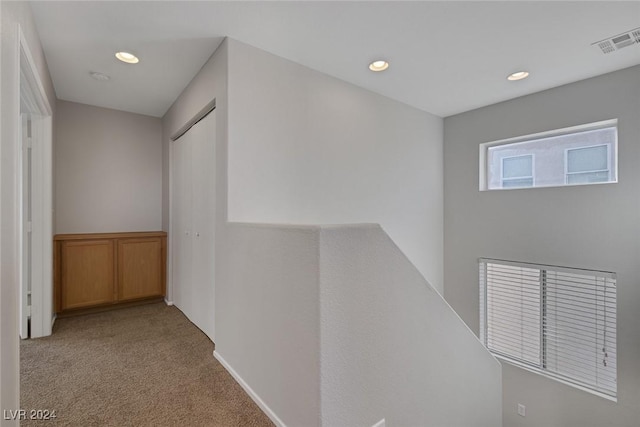 hallway with light carpet