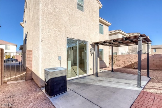 back of property featuring a pergola, a patio area, and central air condition unit