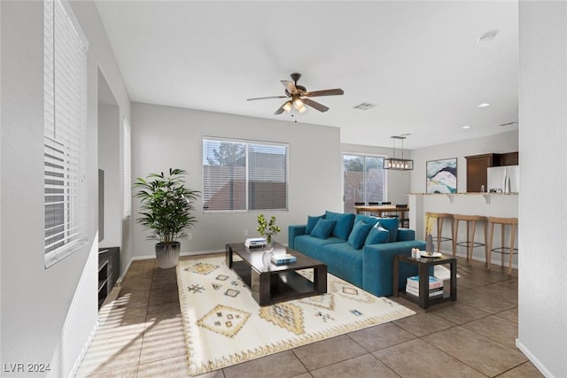 living room featuring ceiling fan and tile patterned flooring