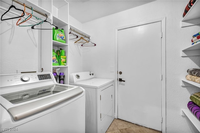 laundry room with light tile patterned flooring and washing machine and dryer