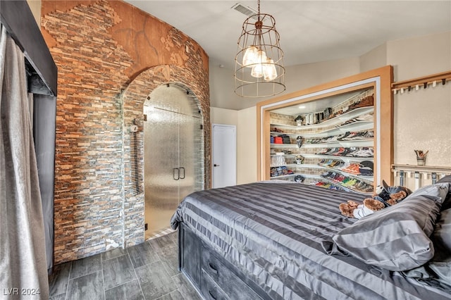 bedroom featuring lofted ceiling and a notable chandelier