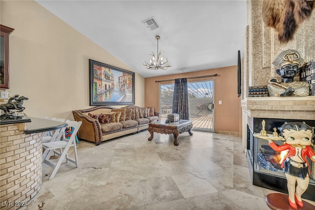 living room with an inviting chandelier, a brick fireplace, and vaulted ceiling